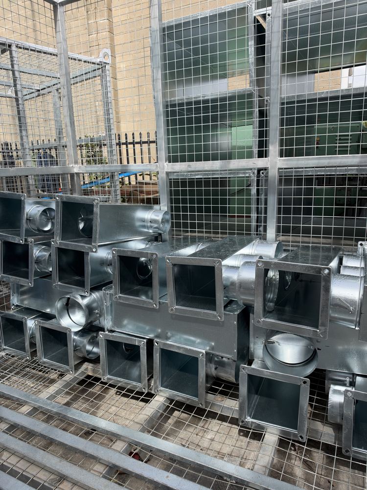 Small fittings stacked in a cage
